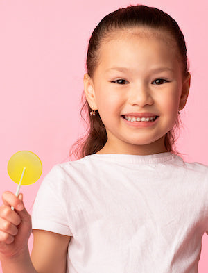 A pretty girl holding a lollipop