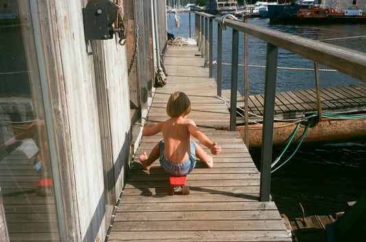 Child on Skateboard on Pier