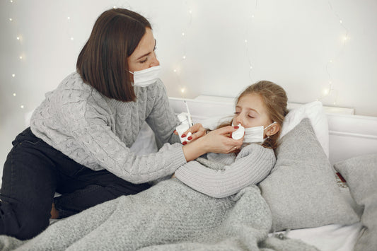 Mother Applying Nose Drops to a Sick Daughter