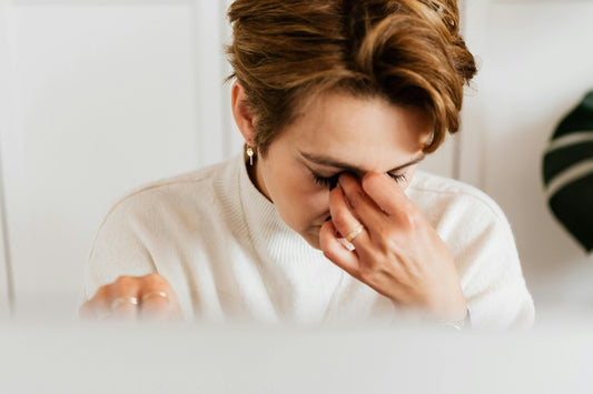 A Woman in White Sweater Covering Her Face