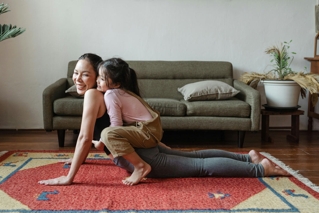 Girl Hugging Her Mom While Doing Yoga Pose